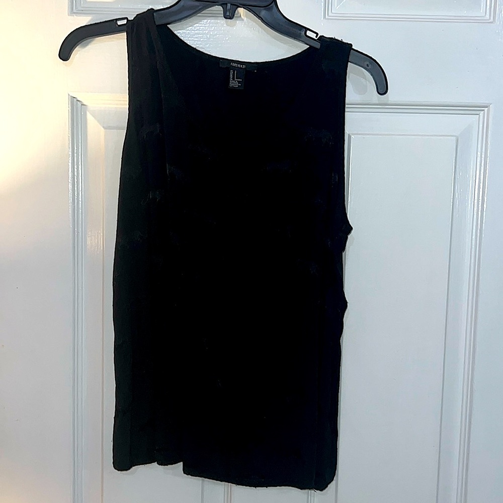 Black top with left pocket. This top has a beautiful animal print.